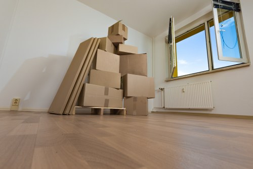Packed moving boxes and furniture prepared for local transport