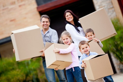 Removalists navigating stairs in a West London flat